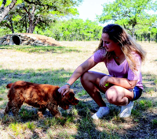 Woman petting dog in Dripping Springs, TX