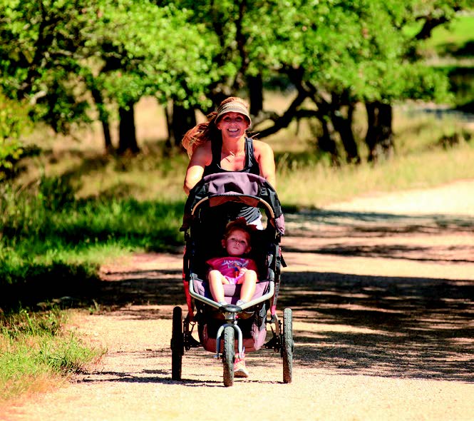 Woman on walking trail with her child in Dripping Springs, TX